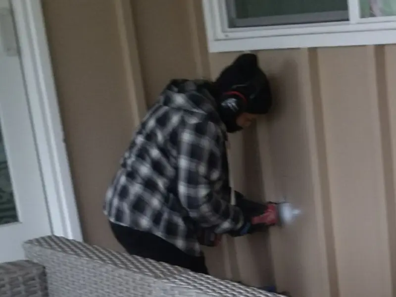 Professional electrician installing an exterior outlet in Hebron